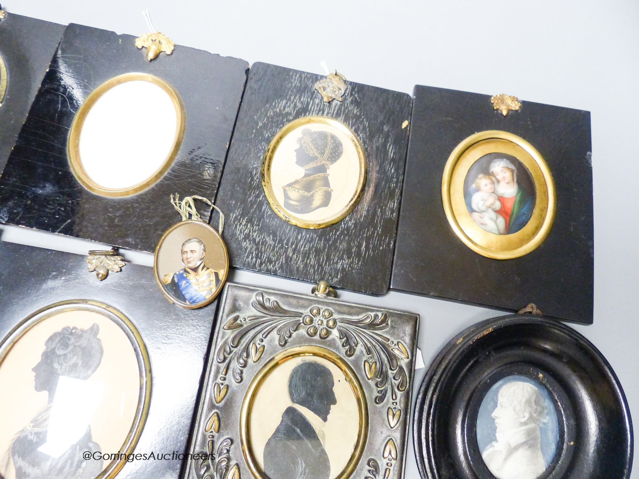 A 19th century portrait miniature, Madonna and child, together with five assorted silhouette portraits and two portraits (8)